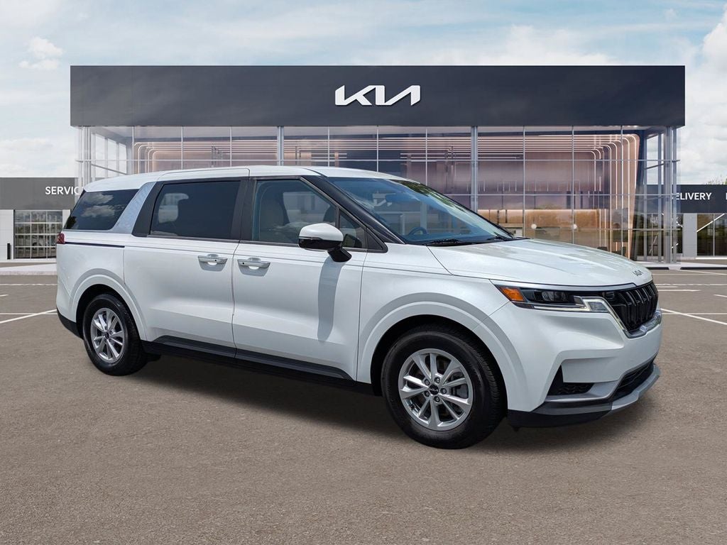 2024 Kia Carnival LX in Snow White Pearl — front three-quarter view