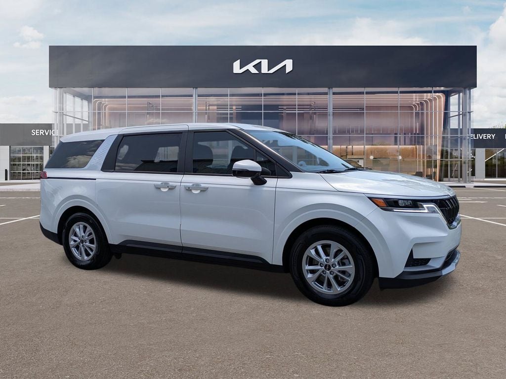 2023 Kia Carnival LX Seat Package in Snow White Pearl — front three-quarter view