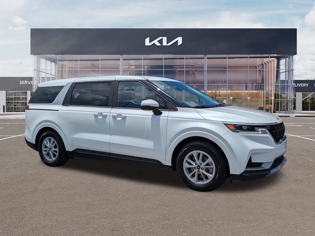 2024 Kia Carnival LX in Snow White Pearl — front three-quarter view