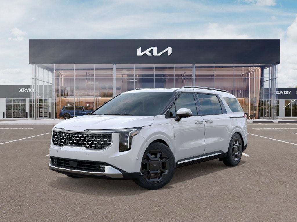 2026 Kia Carnival SX in Snow White Pearl — front three-quarter view