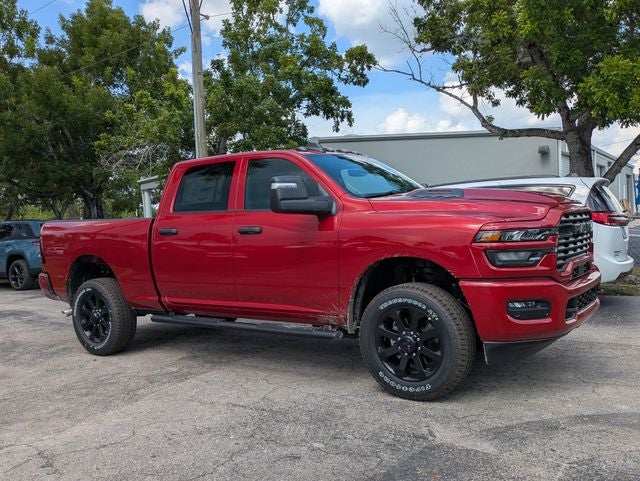 2026 RAM Ram 2500 RAM 2500 BLACK EXPRESS CREW CAB 4X4 6'4' BOX in Molten Red Pearl-Coat Exterior Paint — front three-quarter view